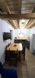 a kitchen with a table and chairs in a room at La puerta el sol in Villanueva del Conde