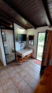 a living room with a table and a television at Apartments Karmen Funtana in Funtana