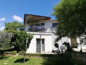 a large white house with a balcony on it at Nice and cozy apartment near Pula in Loborika