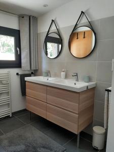 a bathroom with a sink and a mirror at La Colinière, Chambre d'hôtes in Aix-en-Provence +10 photos