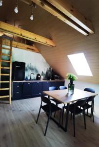 a kitchen and dining room with a table and chairs at Agroturystyka Bocian Biały in Kiwity