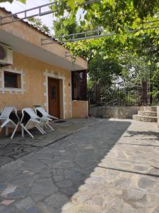 a group of chairs sitting outside of a building at Elpida Apartment in Limenas