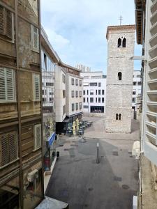 an old building with a clock tower in a city at Apartmani Tower in Rijeka