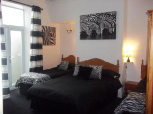 Tempat tidur dalam kamar di The Balmoral & Terrace Guest Houses