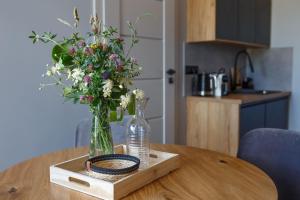 a vase of flowers sitting on a wooden table at Agroturystyka Pod Dębem in Łagów