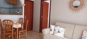 a living room with a couch and a table at Hotel Nou Can Guillem in Cala Figuera