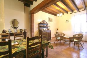 a living room with a table and a dining room at Les Planettes in Saint-Sernin-lès-Lavaur