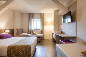 Ένα ή περισσότερα κρεβάτια σε δωμάτιο στο Hotel Alexandra