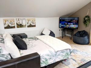 a bedroom with a bed and a flat screen tv at 2 Bed House - Sleeps 6 - Parking - Wifi in Rostrevor