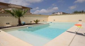 a swimming pool in front of a house at Casa Montalbano in Porto Empedocle