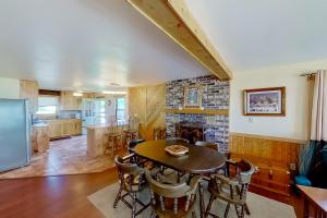 a kitchen and dining room with a table and chairs at The Summer House in Onekama