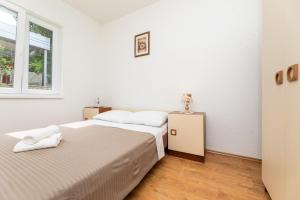 Postel nebo postele na pokoji v ubytování Apartmani Jašarević
