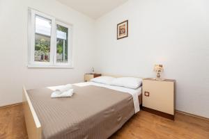 Postel nebo postele na pokoji v ubytování Apartmani Jašarević