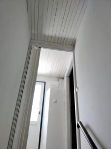 a hallway with a mirror and a door in a room at House Kapetan Nono in Drače