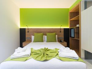 Postel nebo postele na pokoji v ubytování Hotel MG Poniente