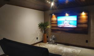 a living room with a flat screen tv on a wall at Loft Antunes in Maricá