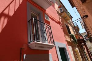a red and white building with a balcony at Vico Nove in Lanciano