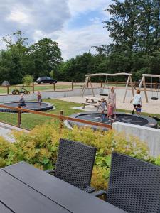 a group of people playing in a playground at LOasen Vesterhede in Hejnsvig