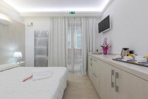 Postel nebo postele na pokoji v ubytování Boutique Hotel Paradiso Bovelacci