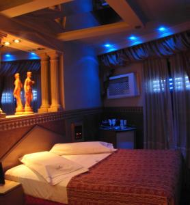 a bedroom with a bed in a room with blue lights at Dallas Hotel -Motel- in Buenos Aires