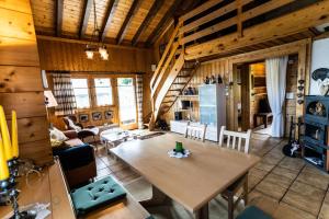 a living room with a table and a kitchen at Chalet Aletschji, 3987 Riederalp, 2. Stock in Riederalp