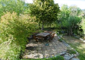 a picnic table and bench in a garden at Appartement d'une chambre avec jardin clos et wifi a Gap in Gap