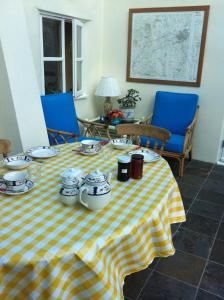 a table with a yellow and white checkered table cloth at Gunville House B&B in Grateley