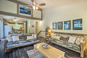 a living room with two couches and a table at Cozy Condo on Fall River - 1 Mile to RMNP Gate! in Estes Park