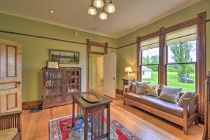 una sala de estar con un sofá y una mesa en Historic, Victorian Villa with Park On-Site, en Quilcene