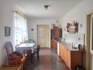 a kitchen with a table and a dining room at Apartmán Měňany in Měňany