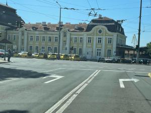 an empty street in front of a large building at Apartment The Room in Burgas City