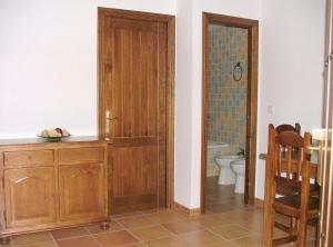 a bathroom with a wooden cabinet and a toilet at Apartamentos Rurales Alcazaba de las Torres in Cañete de las Torres