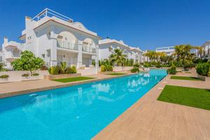 a swimming pool in front of a villa at Esquina Soleada in Ciudad Quesada