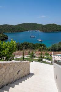 a view of a bay with boats in the water at Sivota Deamaris Luxury Boutique Hotel in Syvota