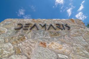 a stone wall with the wordaris written on it at Sivota Deamaris Luxury Boutique Hotel in Syvota