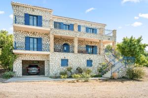 a house with a car parked in front of it at Stone House in olive Grove - former Denis Stone Villa in Trapezaki