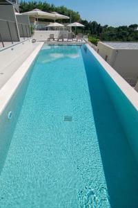 a swimming pool with blue water on a building at Sivota Deamaris Luxury Boutique Hotel in Syvota