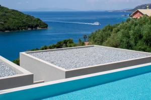a swimming pool with a view of the water at Sivota Deamaris Luxury Boutique Hotel in Syvota