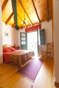 a bedroom with a bed and a large window at Casa Rural Camangu in Camango