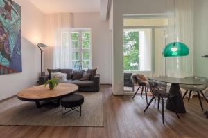 a living room with a couch and a table at Lunas Appartements in der alten Schule Essen in Essen