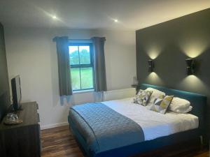 a bedroom with a bed and a window at Luxury, Holiday Home in Orphir overlooking Hoy Hls in Orphir