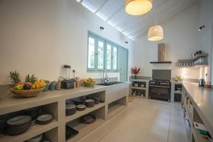 a kitchen with a counter with a bowl of fruit on it at Villa Vanna in Unawatuna