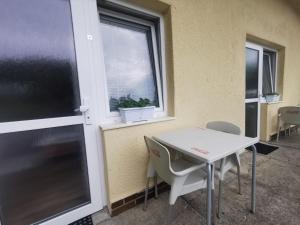 a table and chairs in a room with a window at Apartmány pod Landštejnem in Staré Město