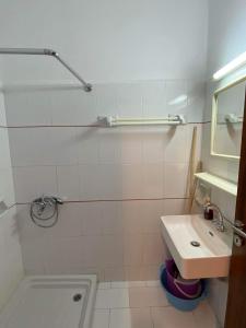a white bathroom with a sink and a shower at Archontika Apartments in Kerames +110 photos