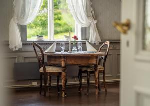 a dining room table with wine glasses and a candle at Husum Hotel in Borgund
