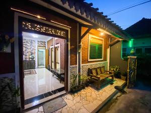 a house with a door to a patio at night at Omah Tukangan Homestay in Yogyakarta