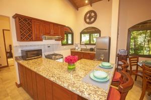 a kitchen with a counter top and a kitchen with a stove at Three Bedroom Two Bath Villa on 20 Acres of Nature! "Hana's Celeste Retreat" in Bijagua