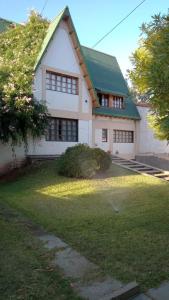 a large white house with a green roof at Casa Verde 2 in Godoy Cruz