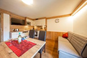 ein Wohnzimmer mit einem Tisch und einer Flasche Wein in der Unterkunft Gästehaus Falkner Ignaz in Sölden