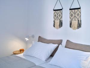 a bedroom with two beds and two lights on the wall at Etherio Apartment II in Piso Livadi